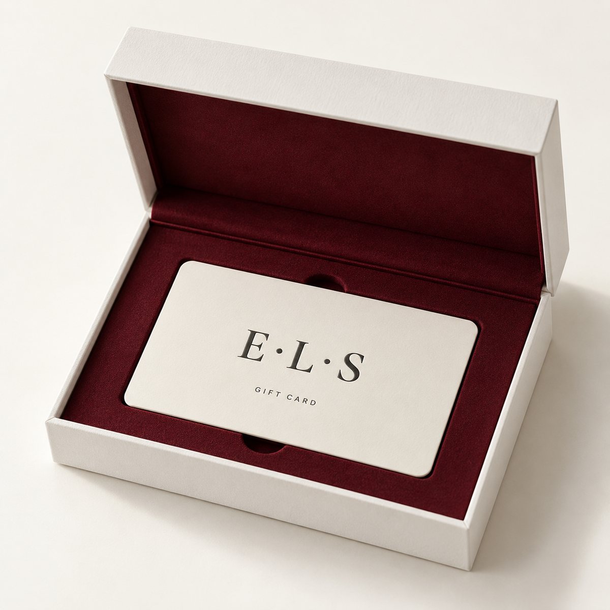 E•L•S gift card in a white presentation box lined with deep red suede