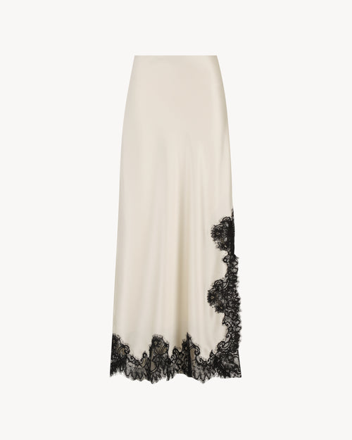 Anouk Maxi Skirt in Feather White, a satin lace skirt with black lace trim and ankle-length silhouette.