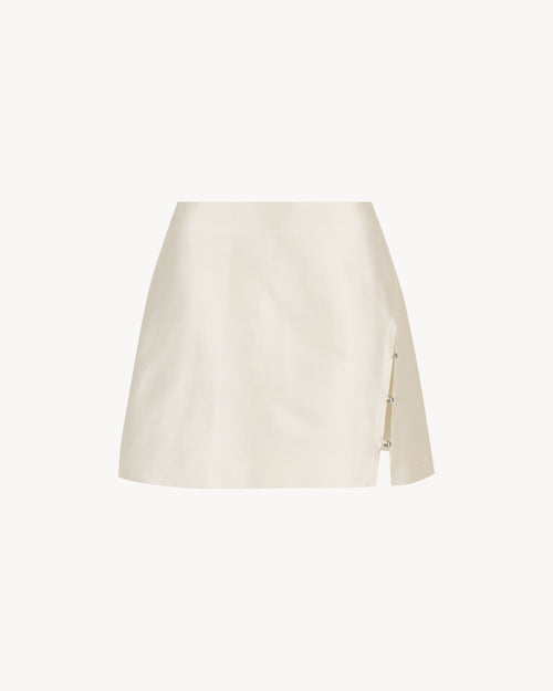 Anya Mini Skirt in Feather White, a wool silk mini skirt with faux-wrap front, side slit and bead detail.