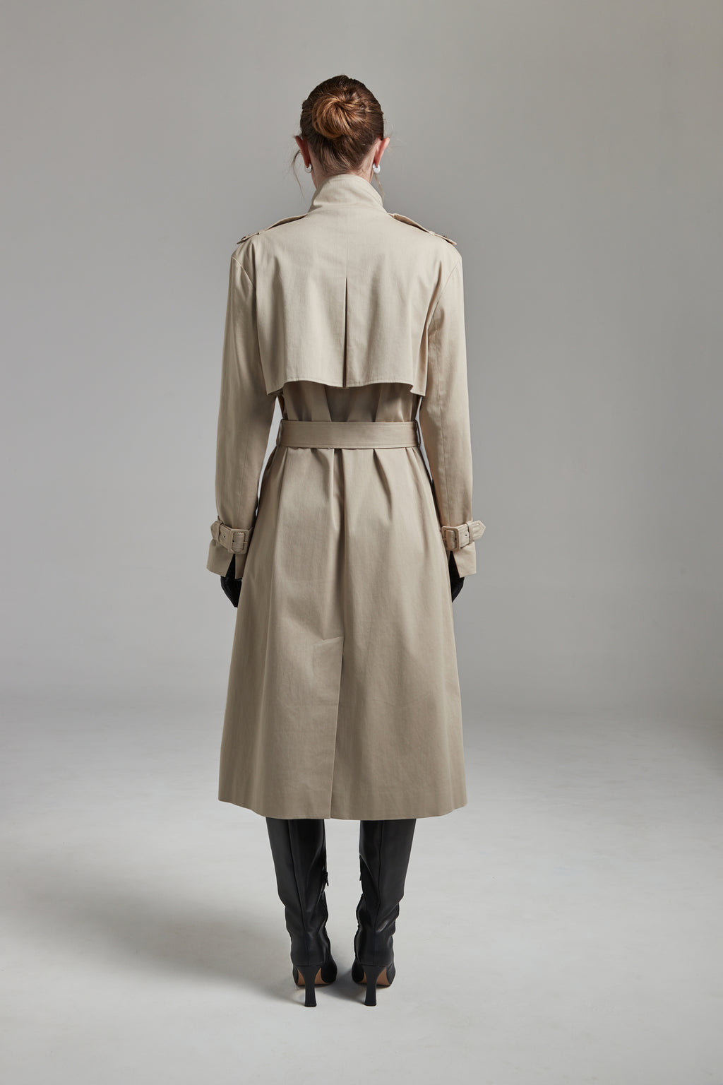 The Celeste Trench Coat in White Pepper shown full-length from the back with a structured outerwear silhouette and clean tailored finish.