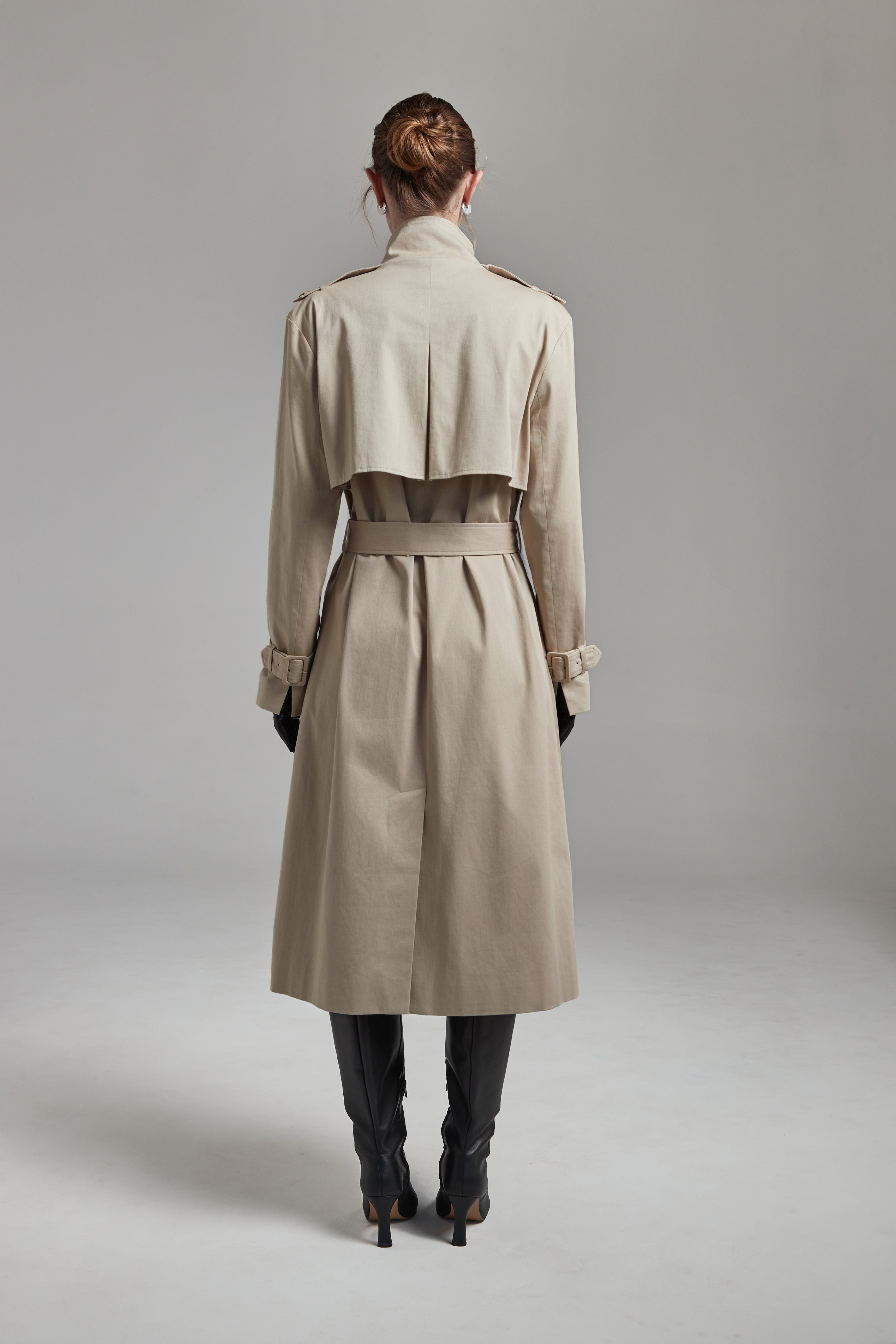 The Celeste Trench Coat in White Pepper shown full-length from the back with a structured outerwear silhouette and clean tailored finish.