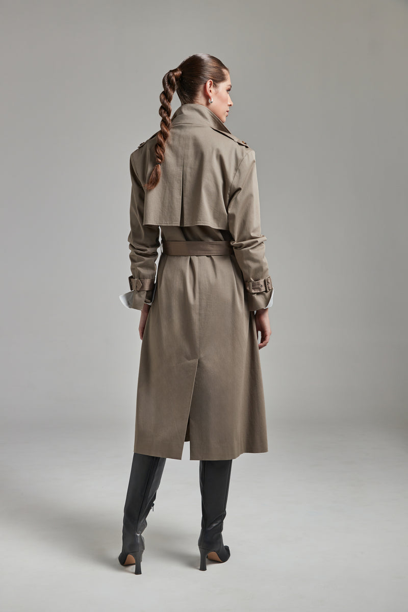 The Celeste Trench Coat in Desert Taupe shown full-length from the back with a funnel neckline and structured outerwear silhouette.