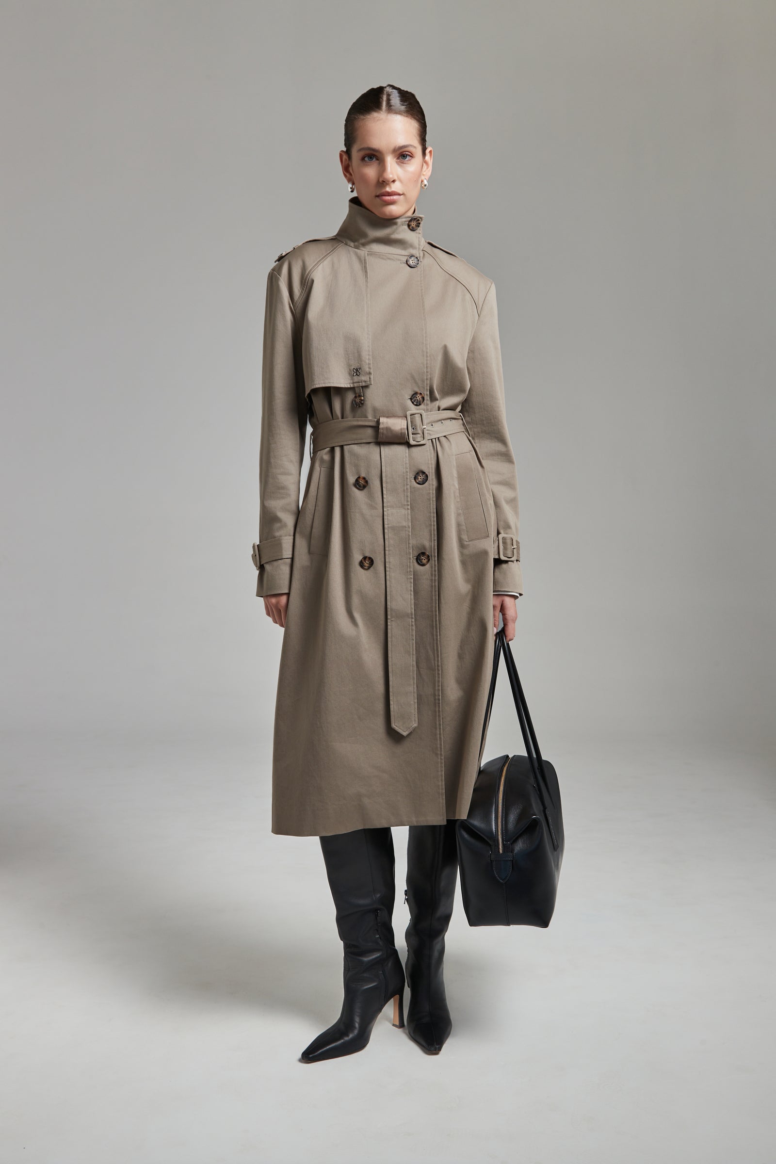 The Celeste Trench Coat in Desert Taupe shown full-length from the front with a funnel neckline and structured outerwear silhouette.