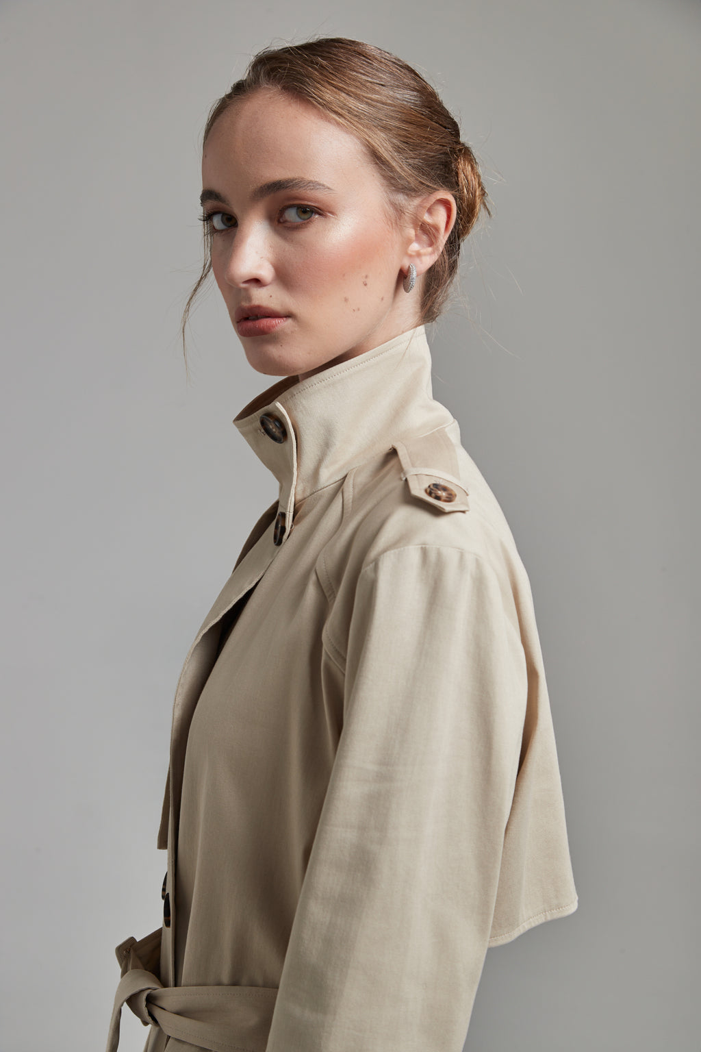 The Celeste Trench Coat in White Pepper shown close-up with a structured funnel collar detail.