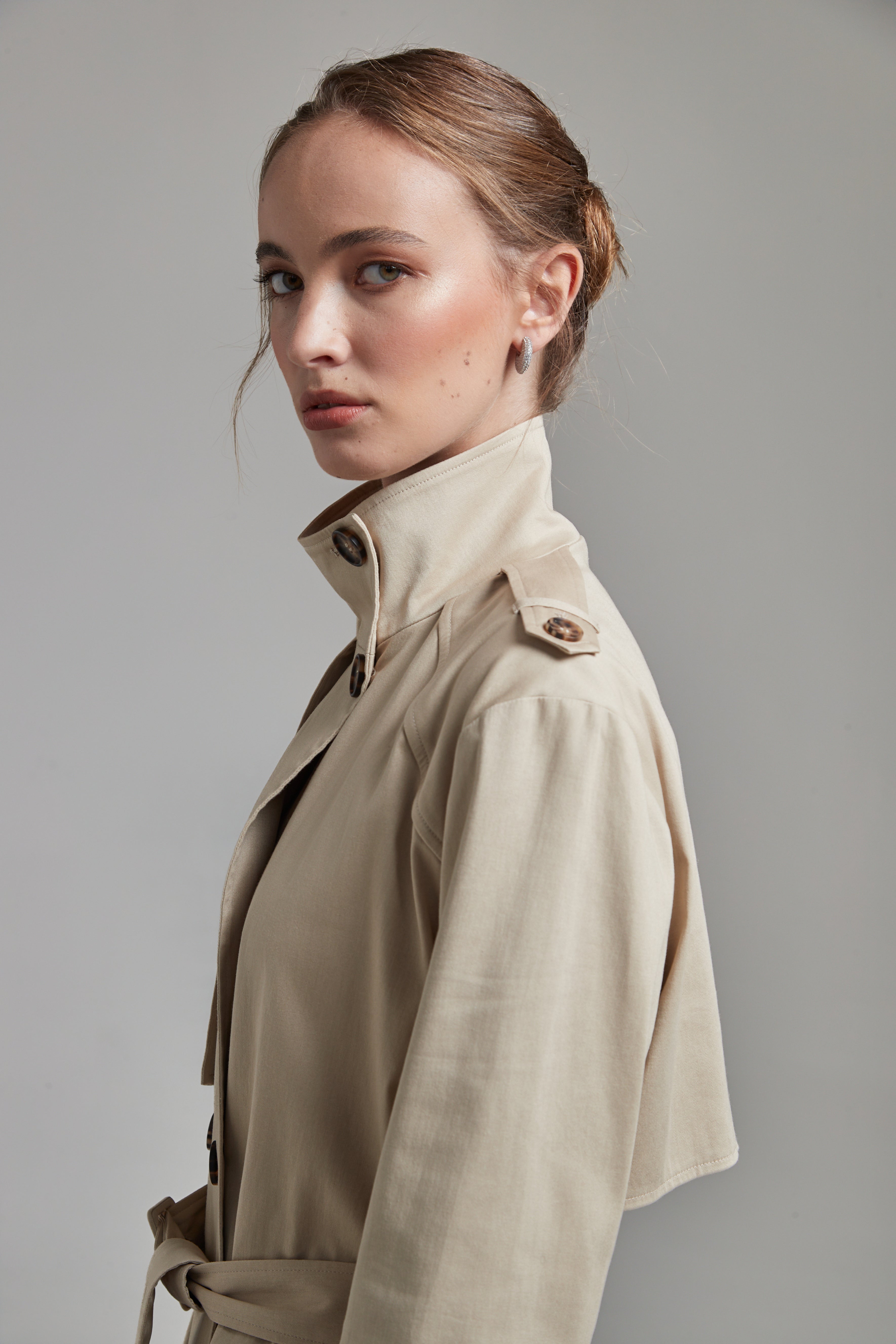 The Celeste Trench Coat in White Pepper shown close-up with a structured funnel collar detail.