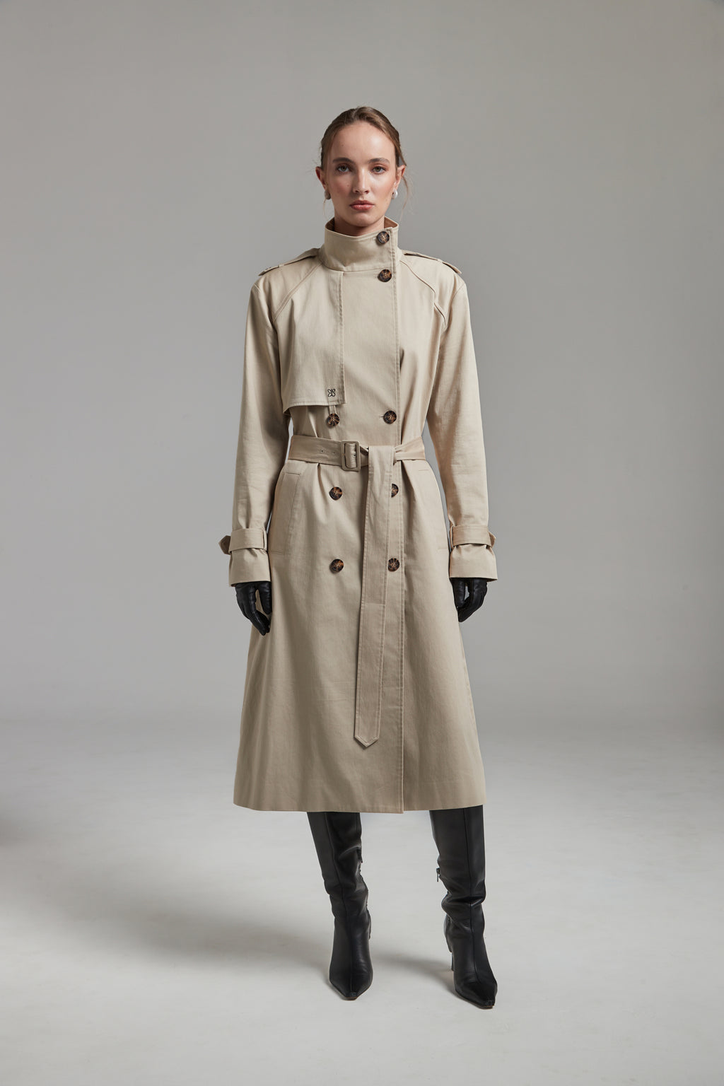 The Celeste Trench Coat in White Pepper shown full-length from the front with a funnel neckline and structured outerwear silhouette.