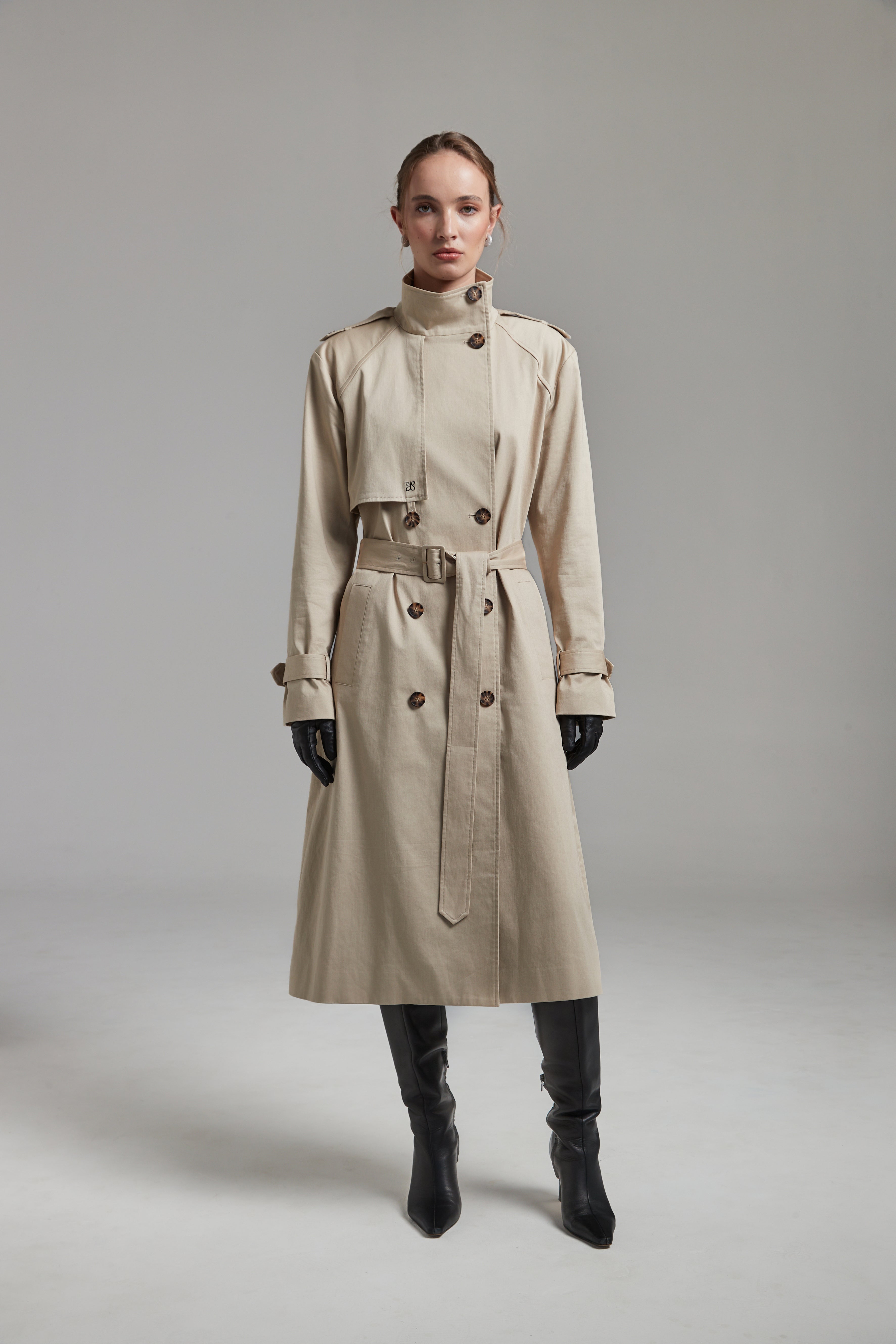 The Celeste Trench Coat in White Pepper shown full-length from the front with a funnel neckline and structured outerwear silhouette.