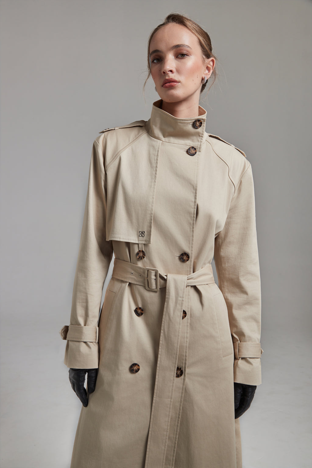 The Celeste Trench Coat in White Pepper shown full-length from the front with a funnel neckline and structured outerwear silhouette.
