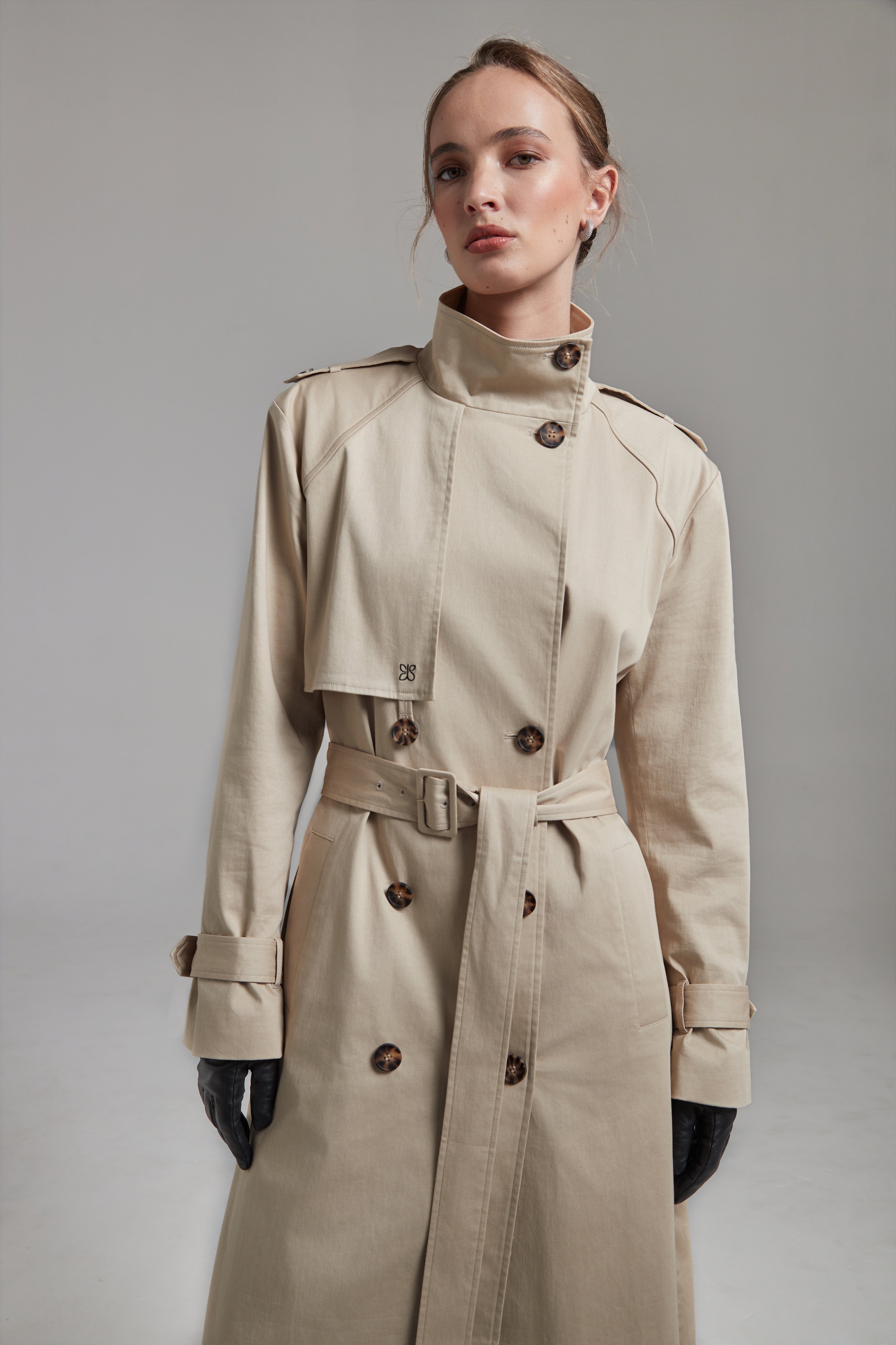 The Celeste Trench Coat in White Pepper shown full-length from the front with a funnel neckline and structured outerwear silhouette.