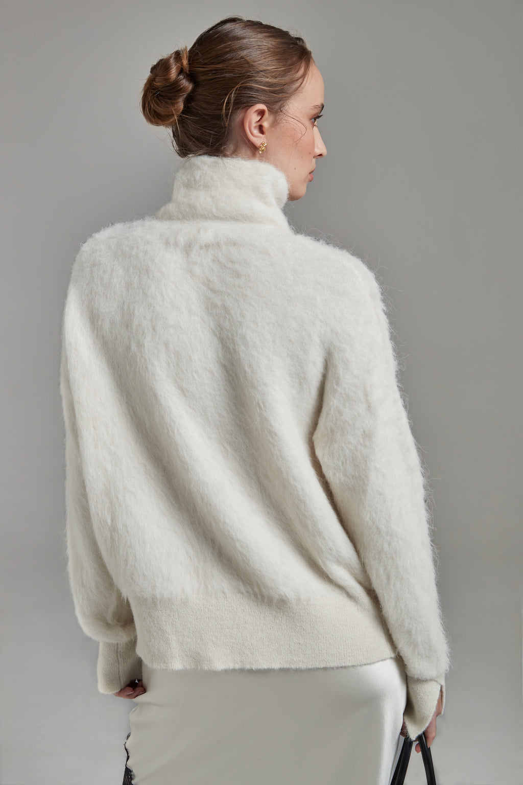 The Lauren Turtleneck in Feather White shown from the back with long sleeves, a brushed alpaca-blend texture and relaxed silhouette.