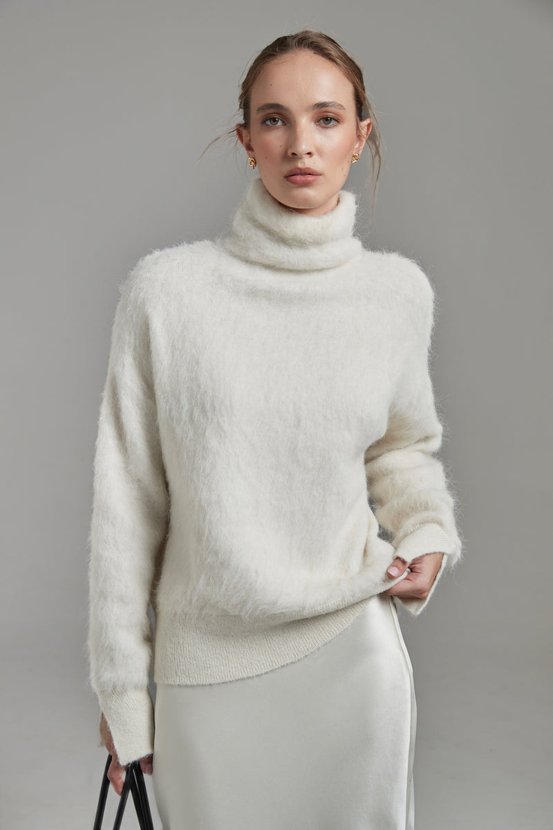 The Lauren Turtleneck in Feather White shown front-on with long sleeves, a brushed alpaca-blend texture and soft stretch.