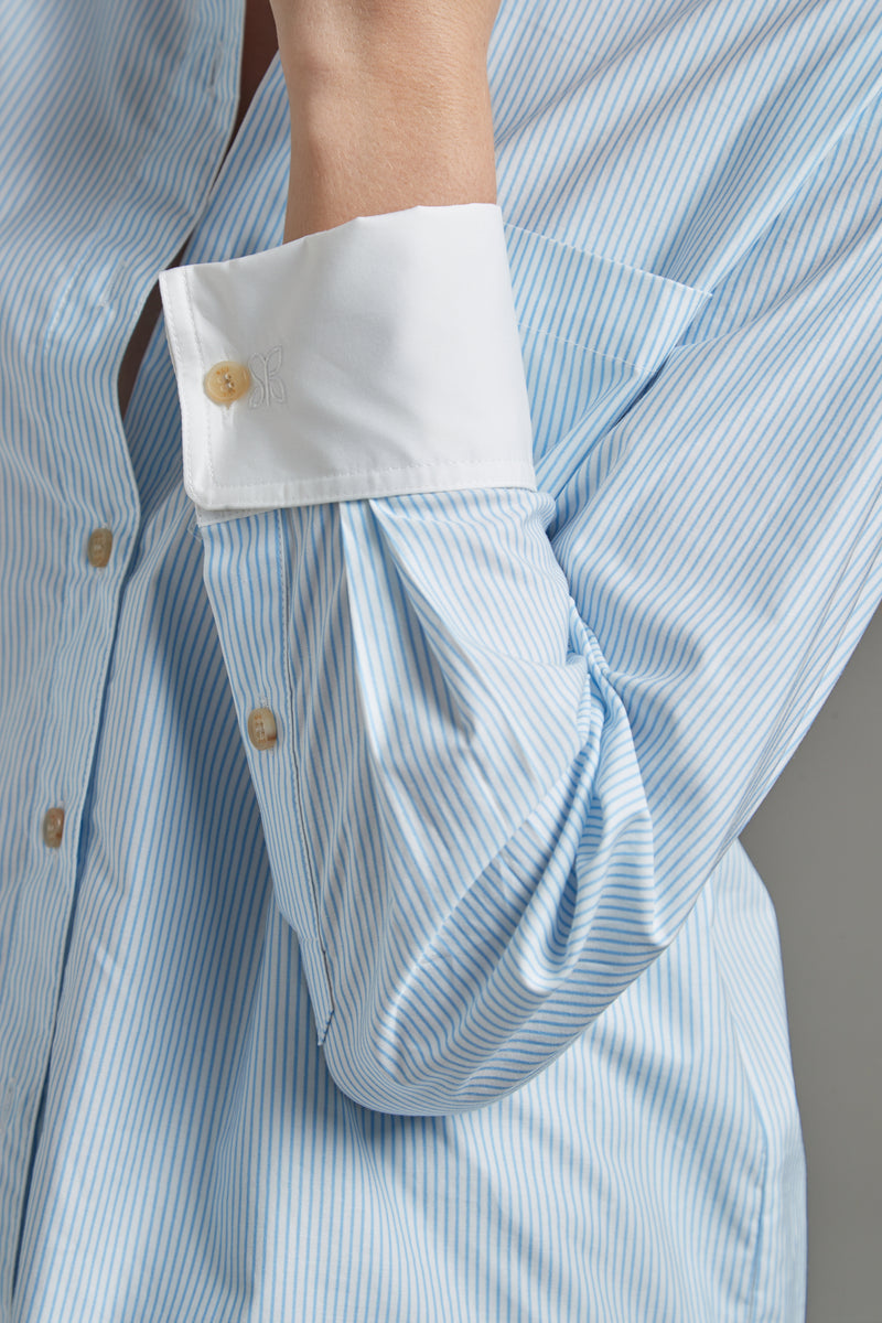 The Margot Shirt – All Tied Up in Blue/White Pinstripe shown close-up with natural horn button detailing and fine pinstripe cotton shirting.