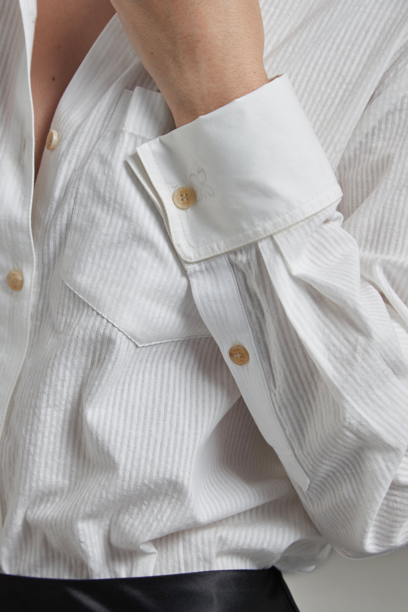 The Margot Shirt in Cloud White shown close-up with cuff detailing, natural horn buttons and tonal cotton shirting.