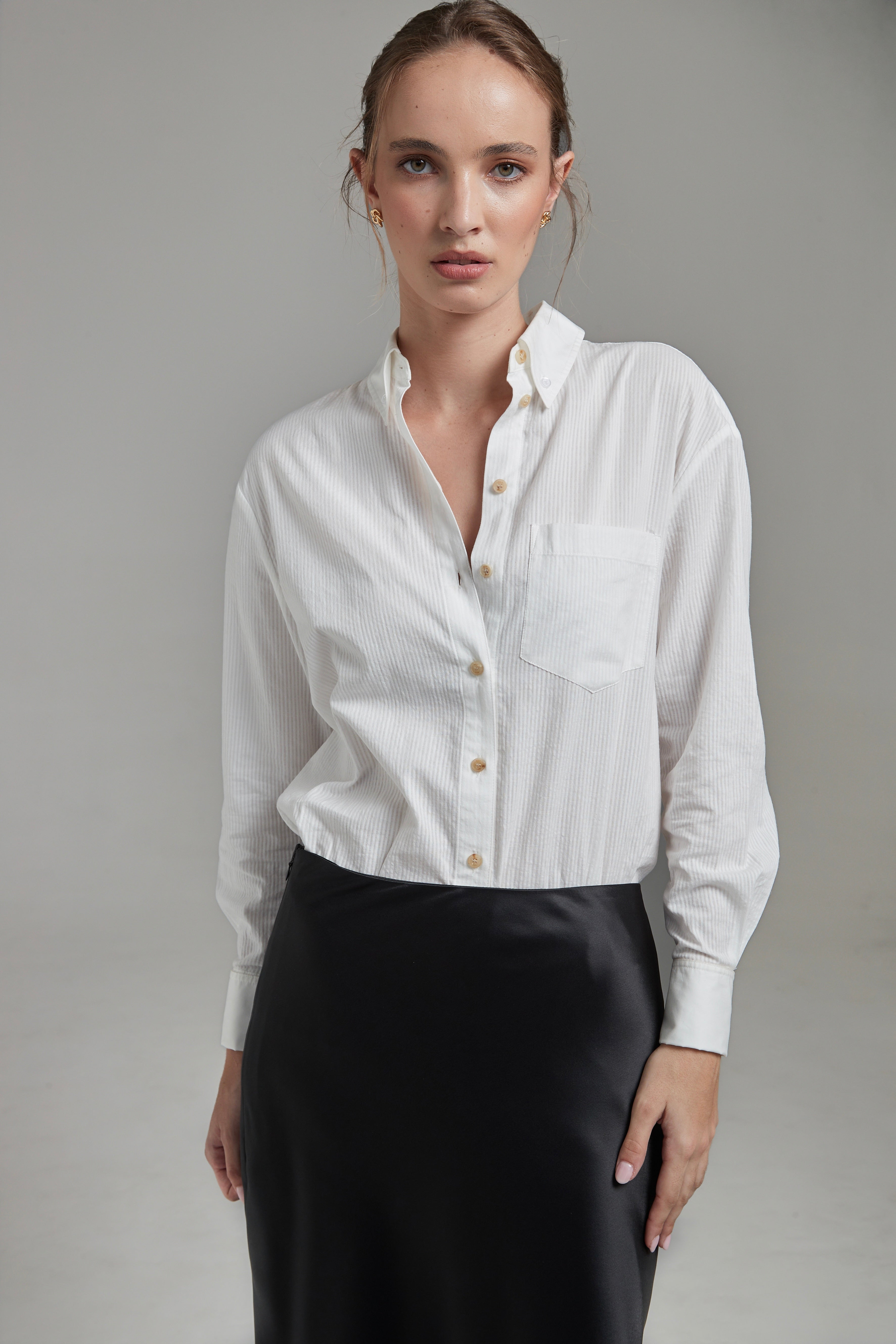 The Margot Shirt in Cloud White shown from the front with tonal cotton shirting, natural horn buttons and a relaxed silhouette.