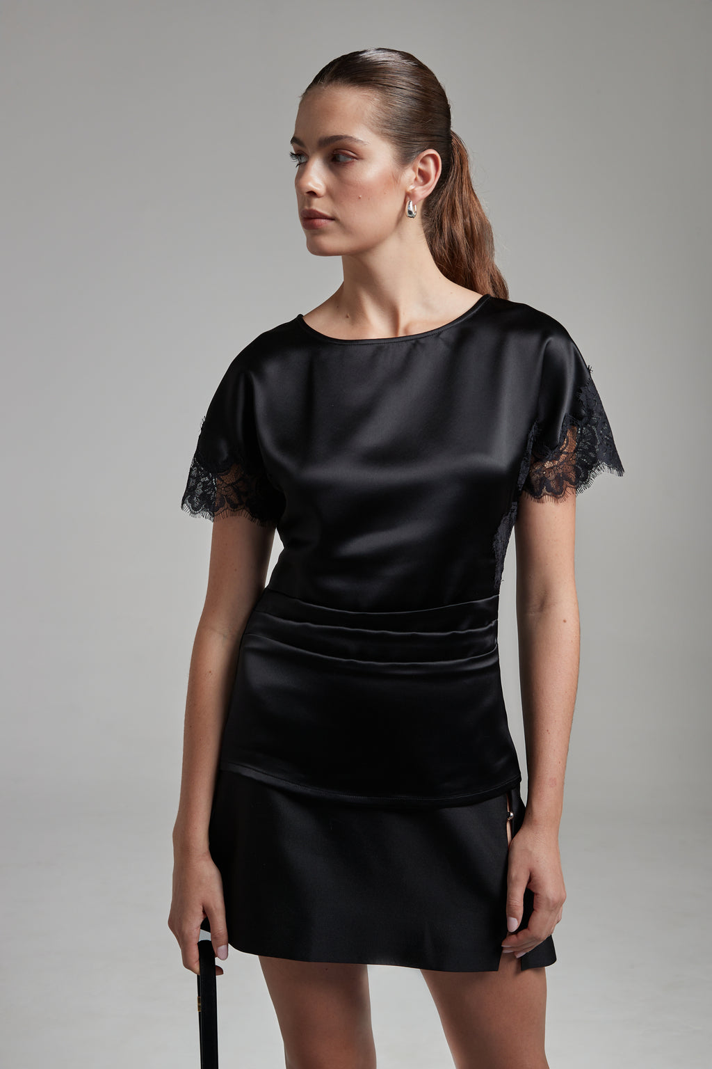 The Paloma Top in Midnight Black shown from the front with tonal lace panel detailing and a fitted silhouette.