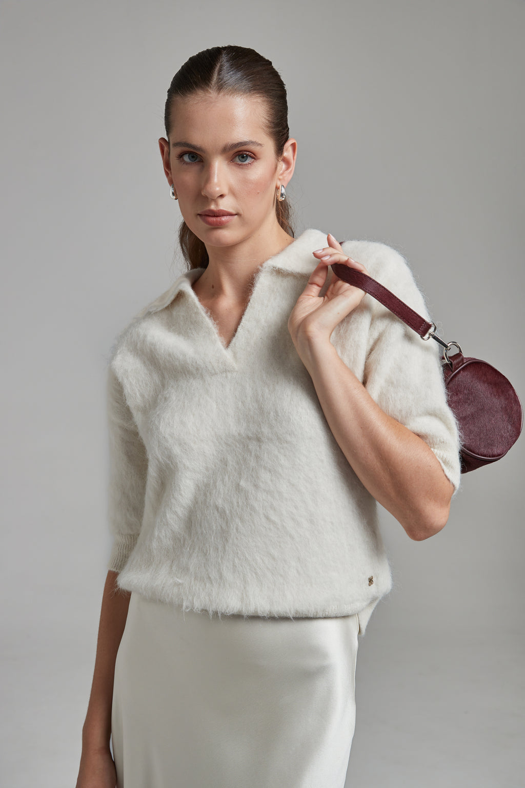 The Stella Polo Knit in Feather White shown front-on with short sleeves, a brushed alpaca-blend texture and soft stretch.
