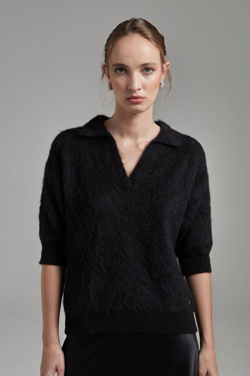 The Stella Polo Knit in Midnight Black shown close-up from the front with short sleeves and a brushed alpaca-blend texture.