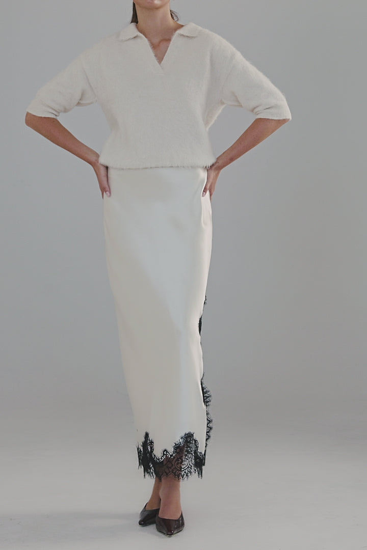 Video showing the Stella Polo Knit in Feather White with close-up details of the brushed alpaca-blend texture, short sleeves and soft stretch.
