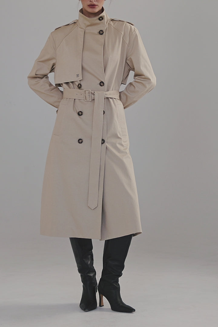 Video showing the Celeste Trench Coat in White Pepper with close-up details of the cotton finish, funnel neckline and structured silhouette.