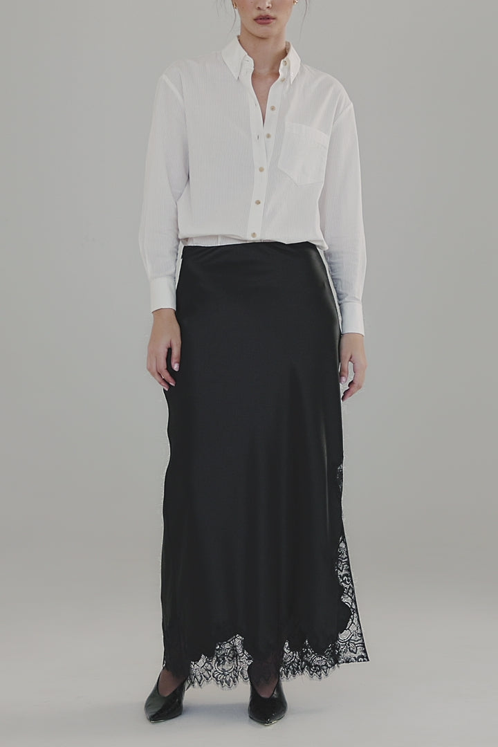 Video showing the Margot Shirt in Cloud White styled with the Anouk Maxi Skirt in Midnight Black, featuring full-length movement, tonal cotton shirting and black lace trim detailing.