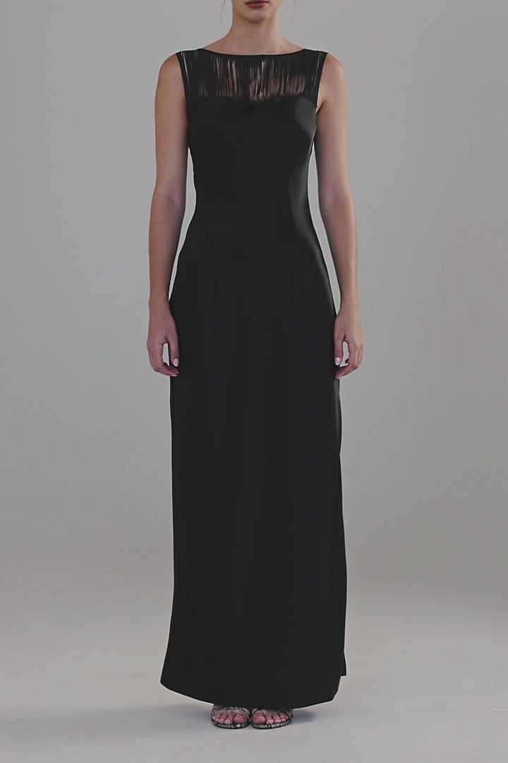 Video showing the Carolyn Maxi Dress in Midnight Black in motion, featuring a satin finish, boat neckline and fringe detailing.