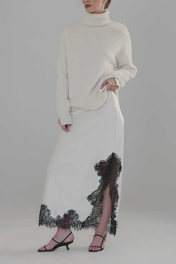 Video showing the Lauren Turtleneck in Feather White with close-up knit texture details and full-length styling views of the brushed alpaca-blend silhouette.