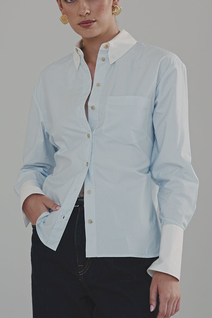Video showing the Margot Shirt – All Tied Up in Blue/White Pinstripe with internal tie-back waist shaping, exaggerated cuffs and a relaxed silhouette.