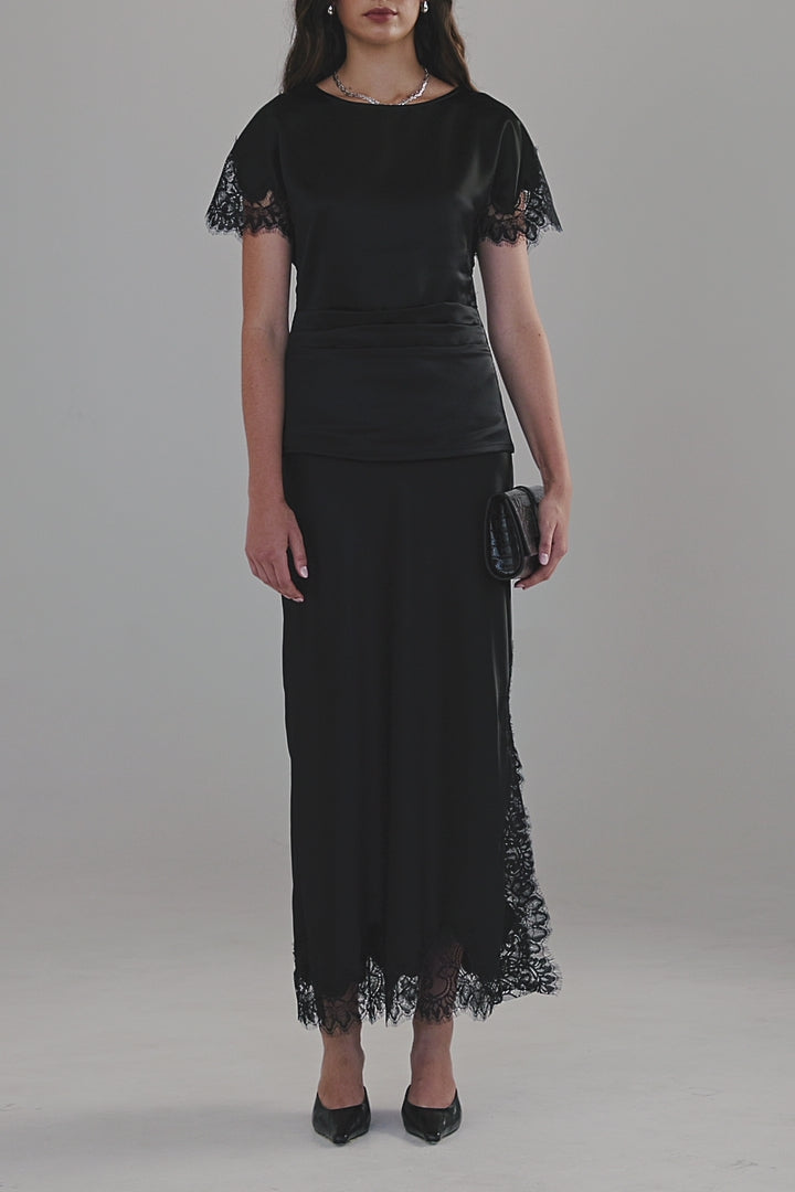 Video showing the Paloma Top in Midnight Black styled with the Anouk Maxi Skirt, featuring satin detailing, tonal lace panels and fluid movement.