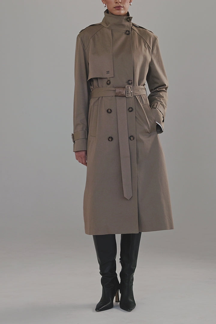 Video showing the Celeste Trench Coat in Desert Taupe with close-up details of the cotton finish, funnel neckline and structured silhouette.